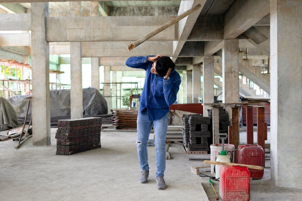 Construction worker injured by falling object on a job site, illustrating need for experienced construction accident lawyer